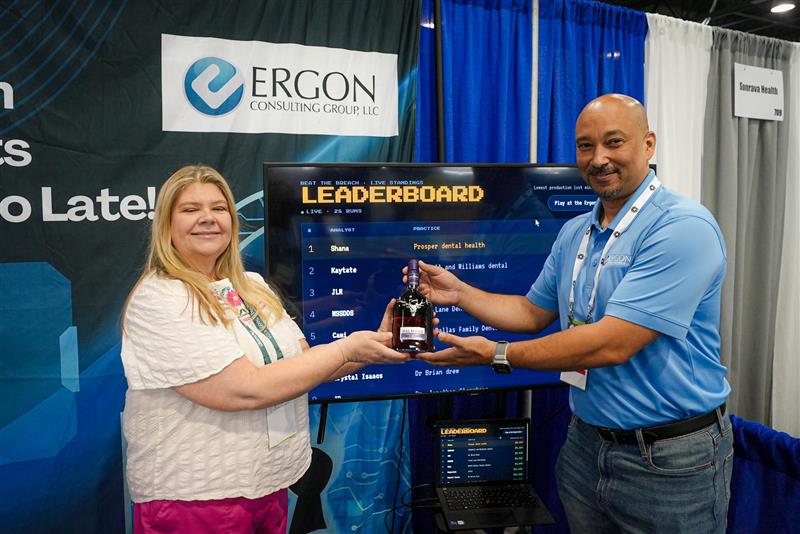 Ergon staff handing a prize to a dental conference winner
