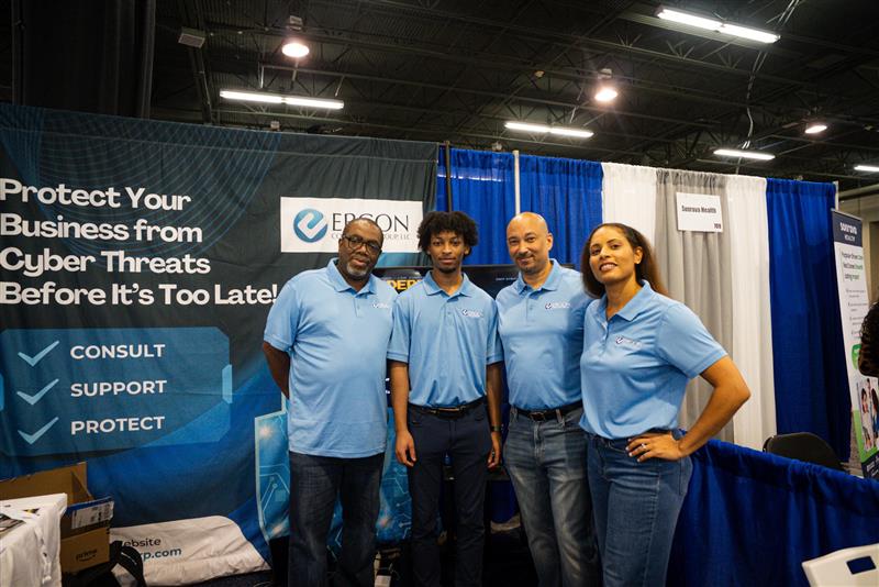 Four Ergon team members posing at the conference booth